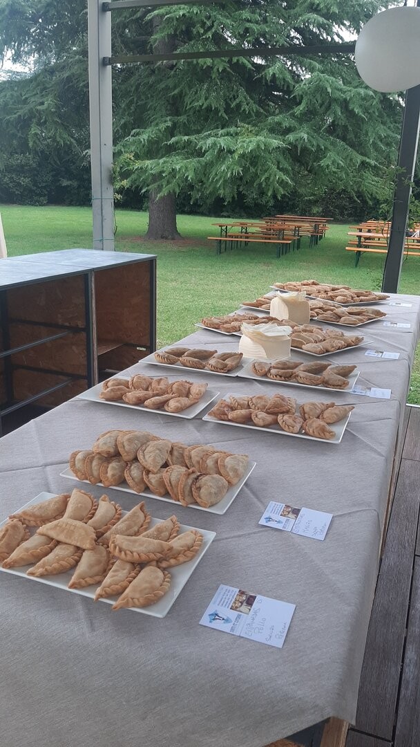 Buffet di empanadas su una lunga tavola apparecchiata all'aperto